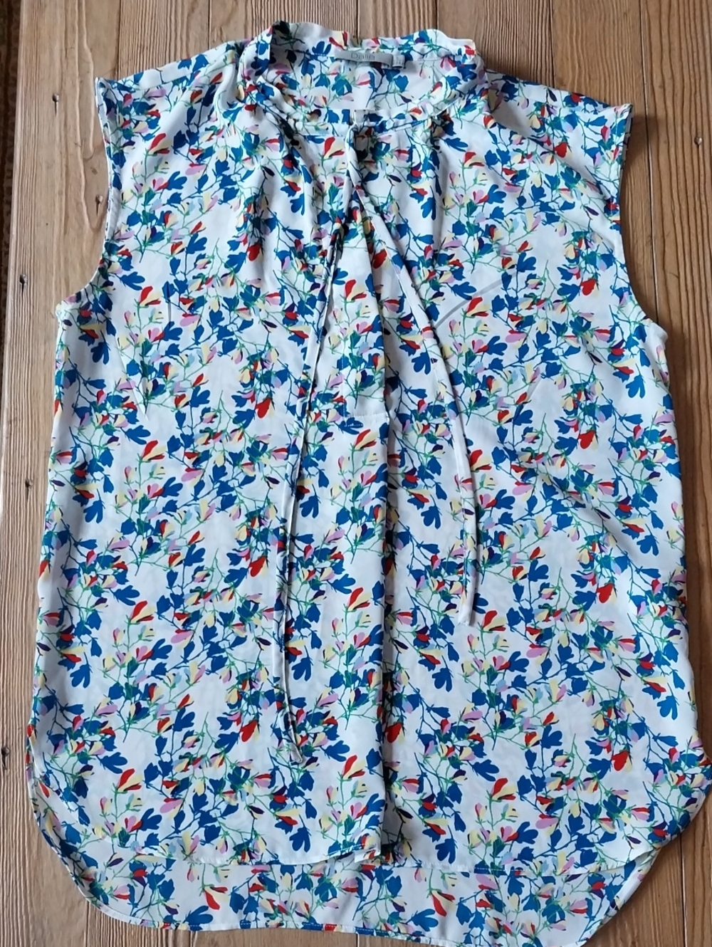 Dalia White Floral Tie-Neck Sleeveless Blouse with Blue and Red Accents